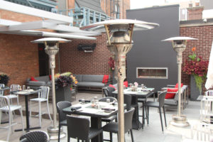 evenglo heaters in silver on outdoor patio